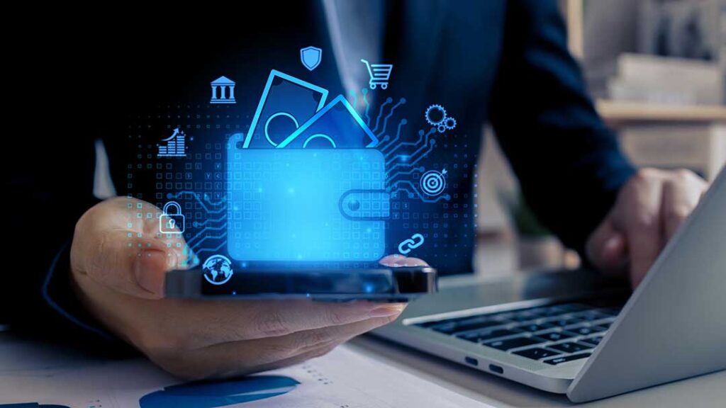 A middle-aged couple reviews investment documents together at a dining table with a laptop and calculator.